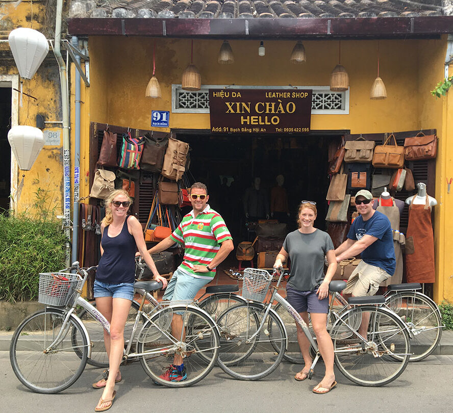 Zoë Wilson and friends on bikes outside a leather workshop in Hot An, Vietnam