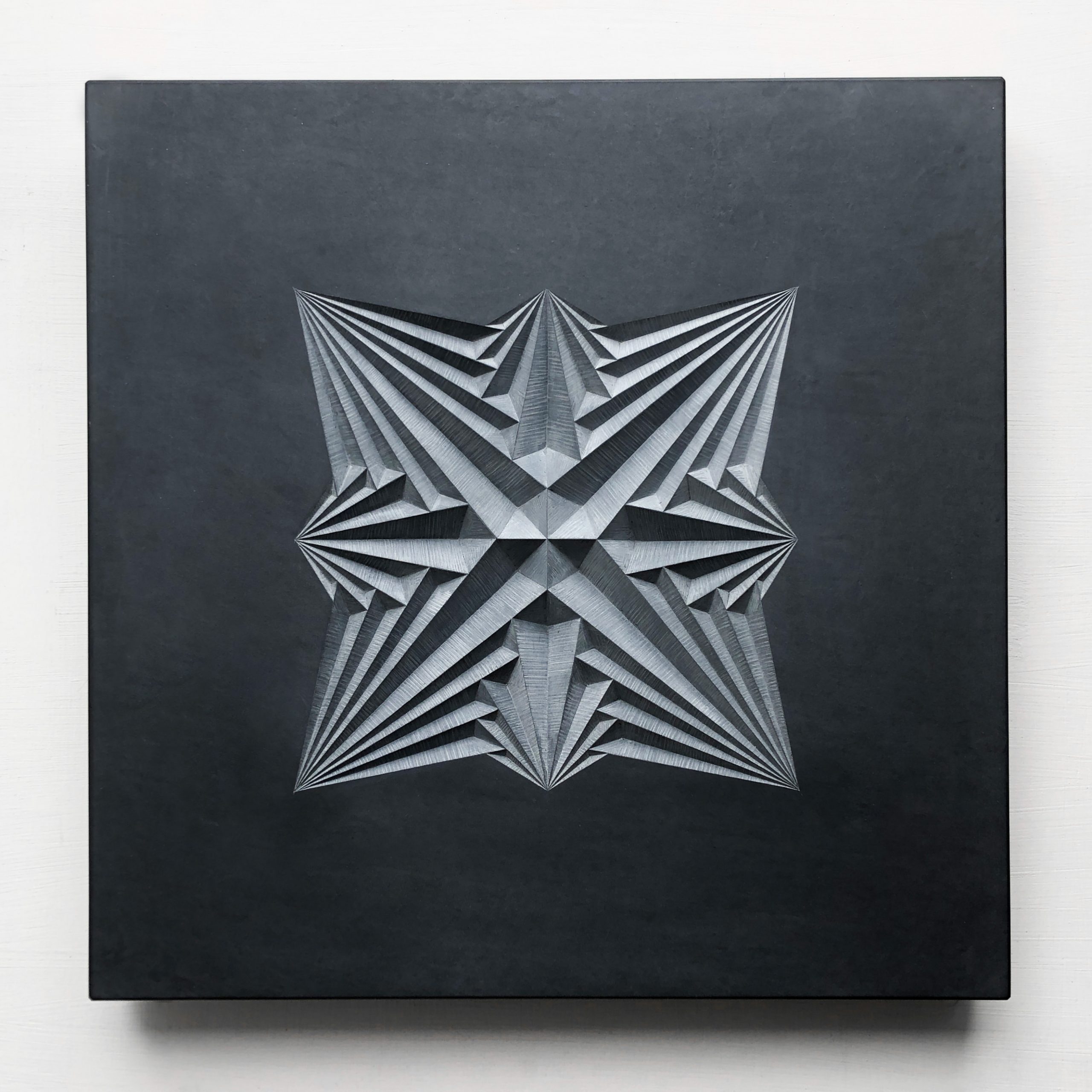 Geometric patter carving into welsh slate by Zoe Wilson