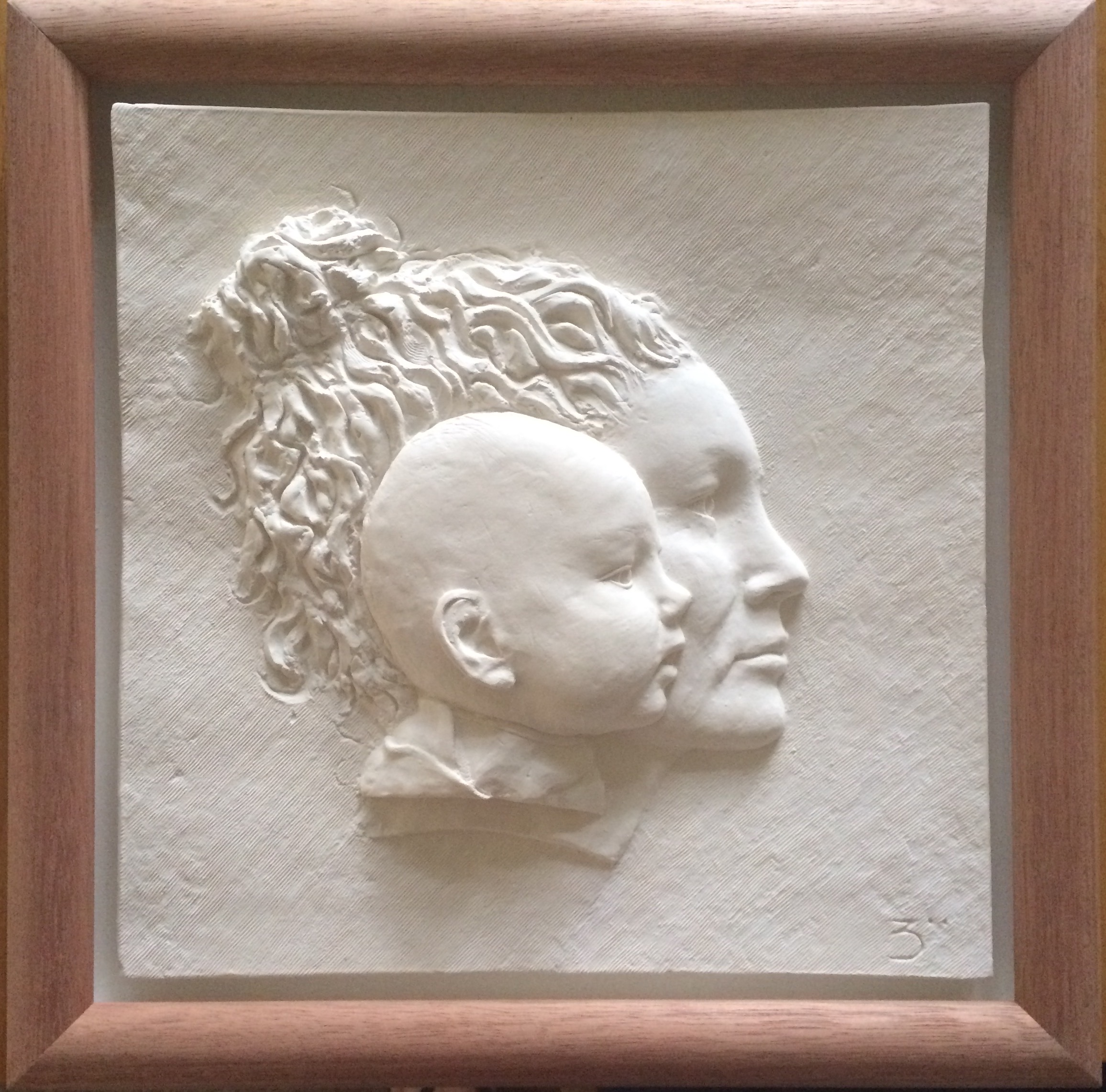 Mother and Babies head modelling in shallow relief and cast in white plaster