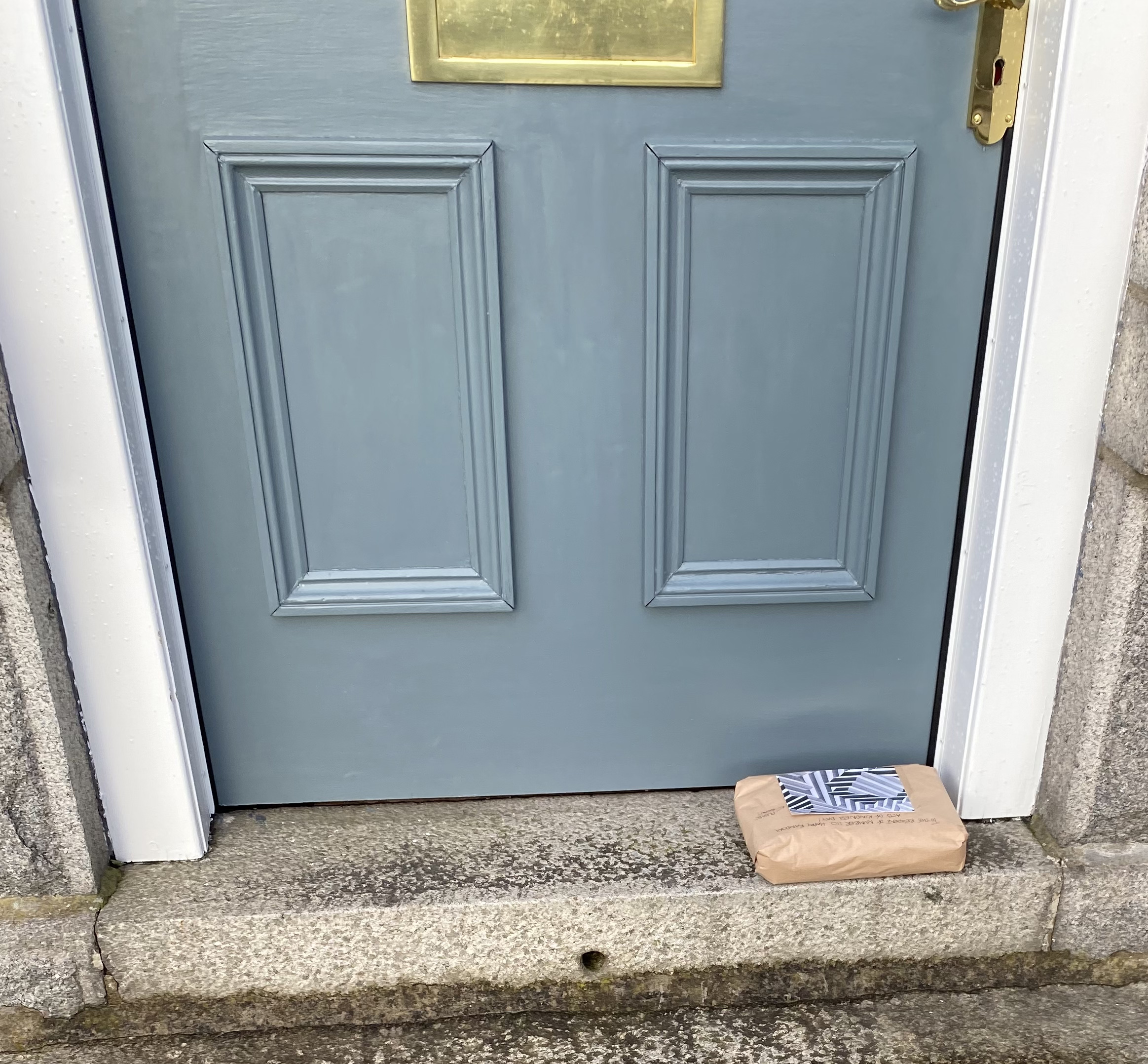 Front door step with package sitting on it