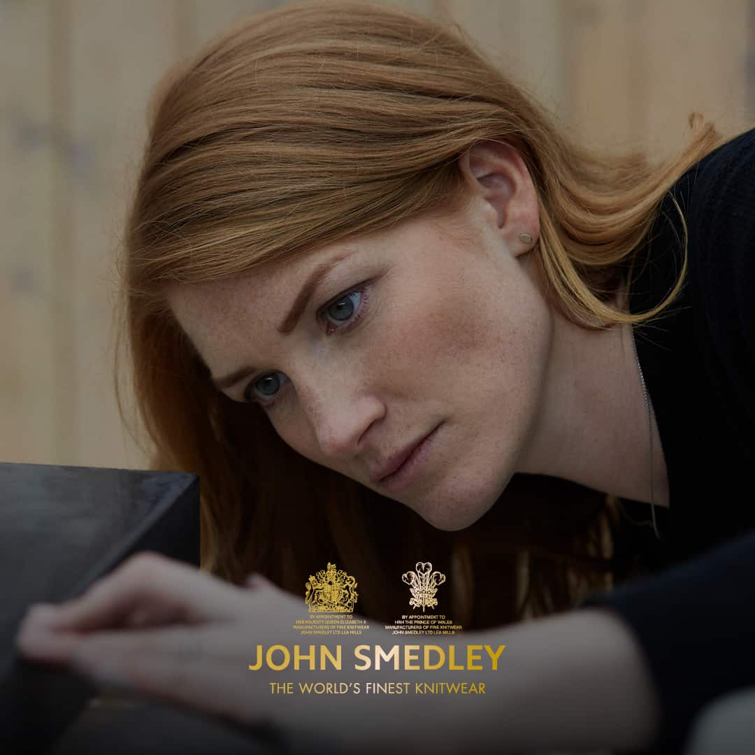 Zoe Working on a piece of stone with the John Smedley logo over the top