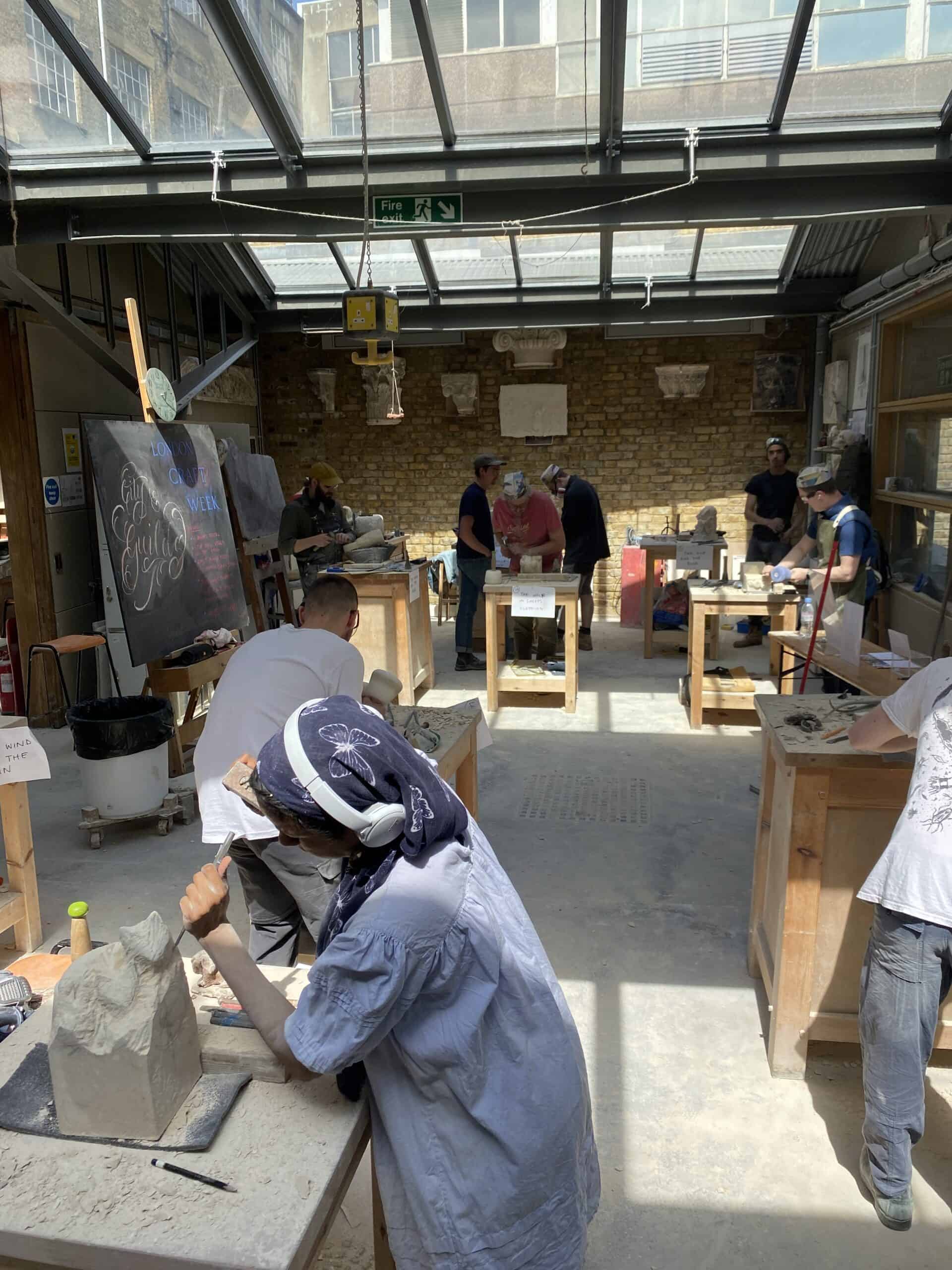 Students carving in the workshop during the competition