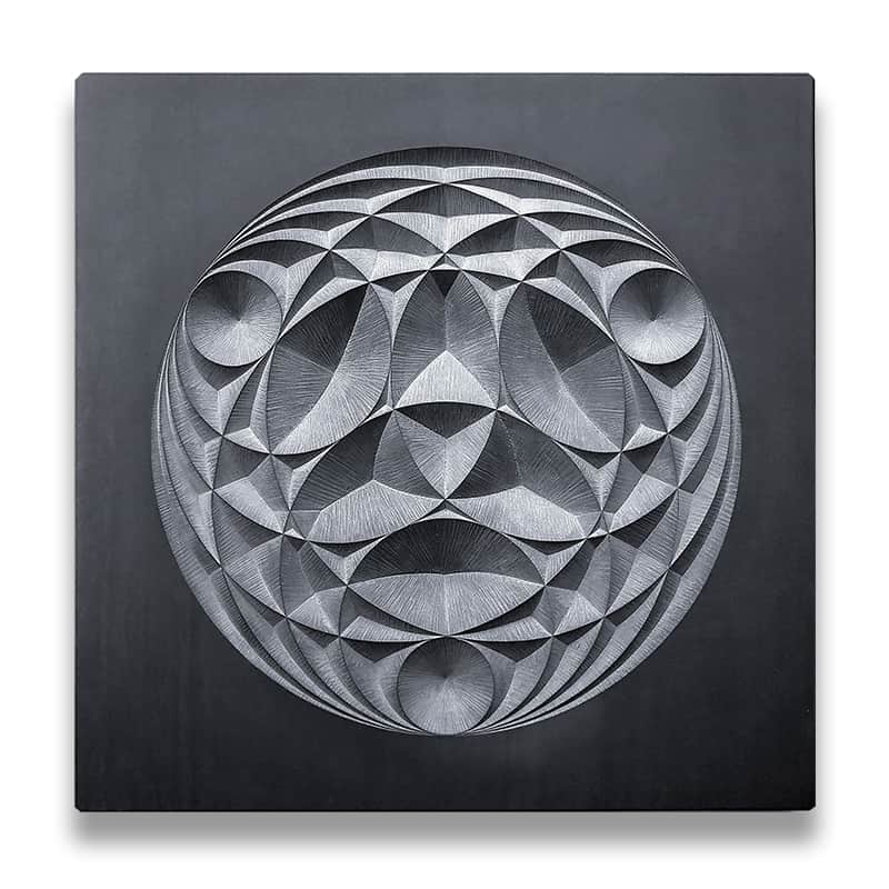 Circular geometric pattern carved into dark grey slate