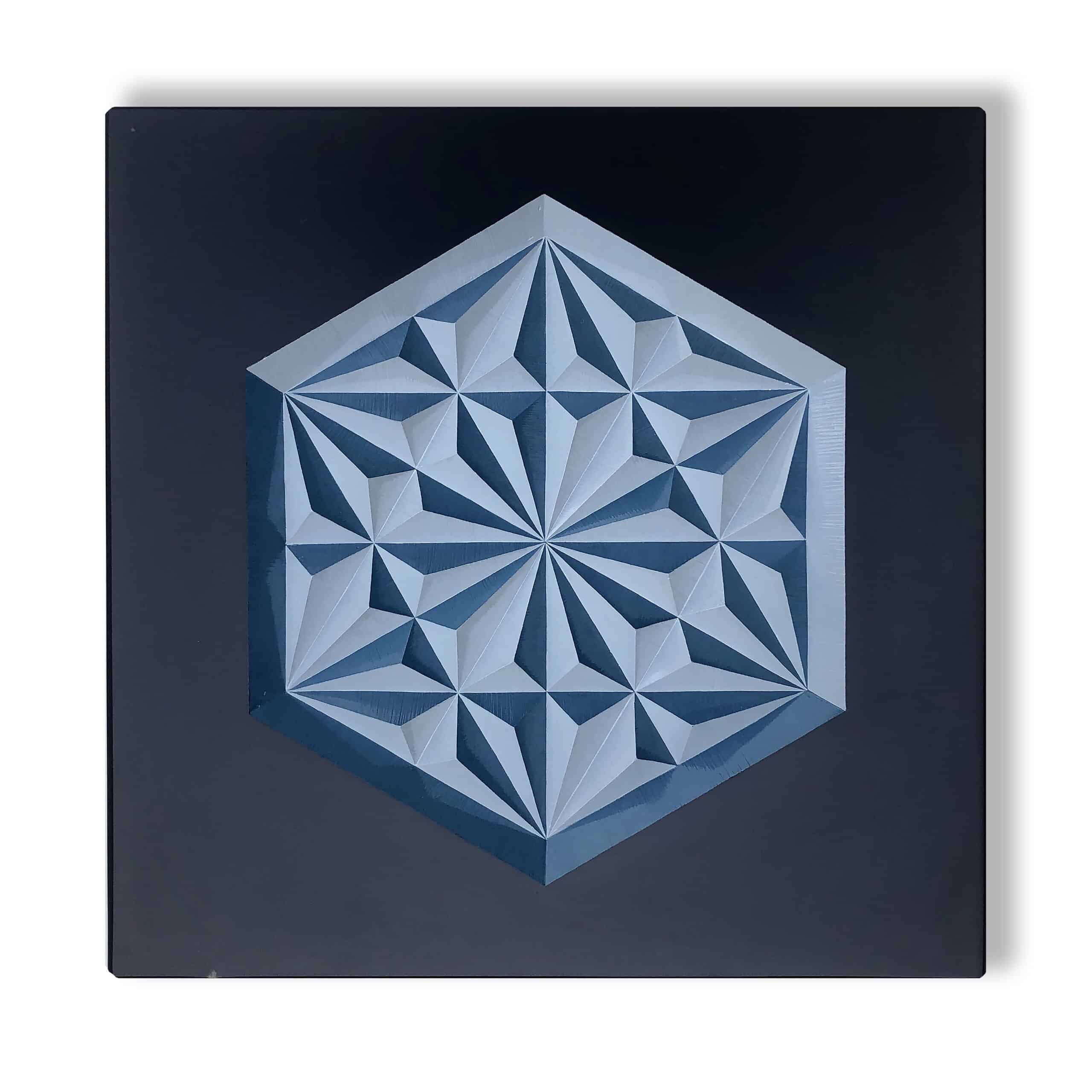 Decorative geometric pattern carved into slate and painted two shades of blue with enamel paint